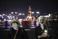 Protesters wear masks during a protest in Hong Kong, Friday, Oct. 18, 2019. Hong Kong pro-democracy protesters are donning cartoon/superhero masks as they formed a human chain across the semiautonomous Chinese city, in defiance of a government ban on face coverings. (AP Photo/Felipe Dana)