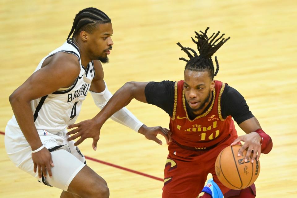 Cavaliers guard Darius Garland dribbles against Nets guard Dennis Smith Jr. in the third quarter, March 10, 2024, in Cleveland.