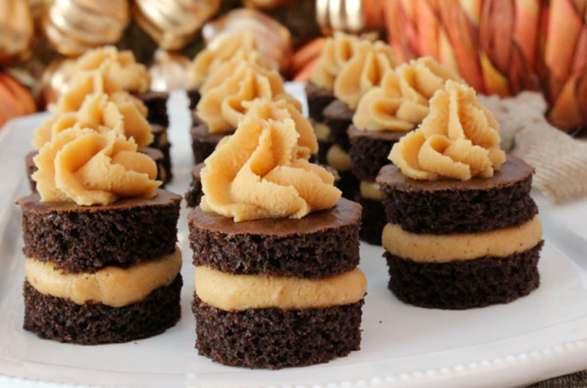 <p>Two Sisters Crafting</p><p>A unique take on a traditional cupcake these fun chocolate cake bites with peanut butter frosting will remind you of a Reese’s peanut butter cup.</p><p><strong>Get the recipe: <a href="https://www.twosisterscrafting.com/chocolate-cake-bites-with-peanut-butter-frosting/" rel="nofollow noopener" target="_blank" data-ylk="slk:Chocolate Cake Bites with Peanut Butter Frosting;elm:context_link;itc:0;sec:content-canvas" class="link rapid-noclick-resp">Chocolate Cake Bites with Peanut Butter Frosting</a></strong></p>