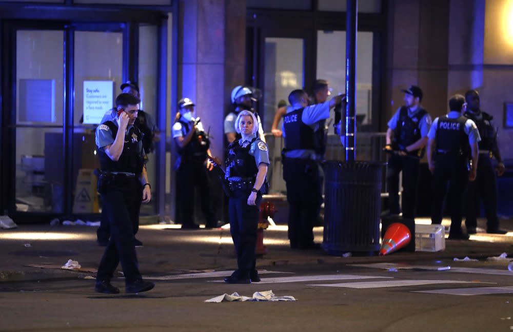 Chicago police gather after rioting and looting occurred in the Gold Coast area of the city early in the morning of Monday, Aug. 10, 2020. (Jose M. Osorio /Chicago Tribune via AP)