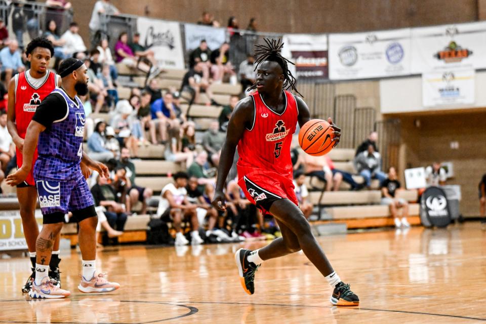 Michigan State freshman and Team Goodfellas' Kur Teng moves the ball against Team Case Credit Union in the Tuesday, June 25, 2024, game during the Moneyball Pro-Am at Holt High School.