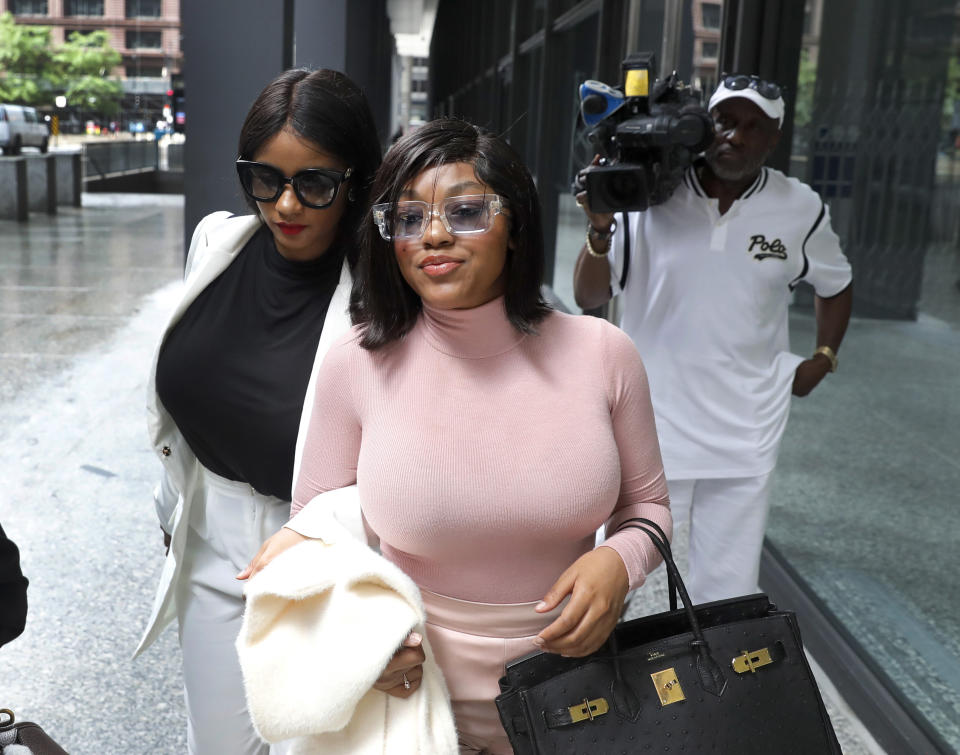 CORRECTS THE DESCRIPTION OF THE TWO WOMEN AS HAVING LIVED WITH R. KELLY RATHER THAN GIRLFRIENDS - Joycelyn Savage, left, and Azriel Clary, women who lived with R&B singer R. Kelly, depart the Dirksen Federal Courthouse after Kelly's hearing, Tuesday, July 16, 2019, in Chicago. U.S. District Judge Harry Leinenweber ordered R. Kelly held in a Chicago jail without bond on sex-related charges, saying that R&B singer had failed to convince the court that he would not be a danger if set free. (AP Photo/Charles Rex Arbogast)