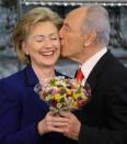 <p>Israeli President Shimon Peres, right, kisses U.S. Secretary of State Hillary Rodham Clinton, after giving her a posy of flowers, during their meeting at Peres’ residency in Jerusalem, Tuesday, March 3, 2009. (AP Photo/Ariel Schalit) </p>