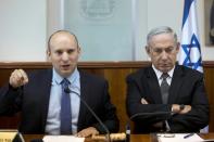 Israeli Prime Minister Benjamin Netanyahu (R) listens to Education Minister Naftali Bennett during a cabinet meeting, in a file photo taken on August 30, 2016