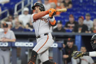 San Francisco Giants' Thairo Estrada hits a double to left field during the second inning of a baseball game against the Miami Marlins, Wednesday, April 17, 2024, in Miami. Jorge Soler scored on the play. (AP Photo/Marta Lavandier)