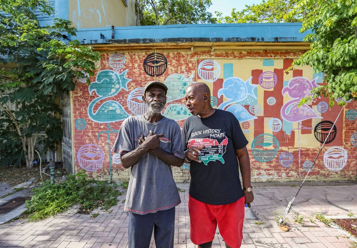 Lifelong residents Michael Williams, 63, and Randy Russ, 67, stand in front of the shuttered Tiki Club on Grand Avenue in Miami’s Coconut Grove on Thursday, June 16, 2022.