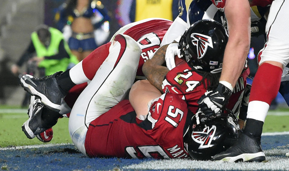 <p>Atlanta Falcons running back Devonta Freeman (24) scores against the Los Angeles Rams during the first half of an NFL football wild-card playoff game Saturday, Jan. 6, 2018, in Los Angeles. (AP Photo/Mark J. Terrill) </p>