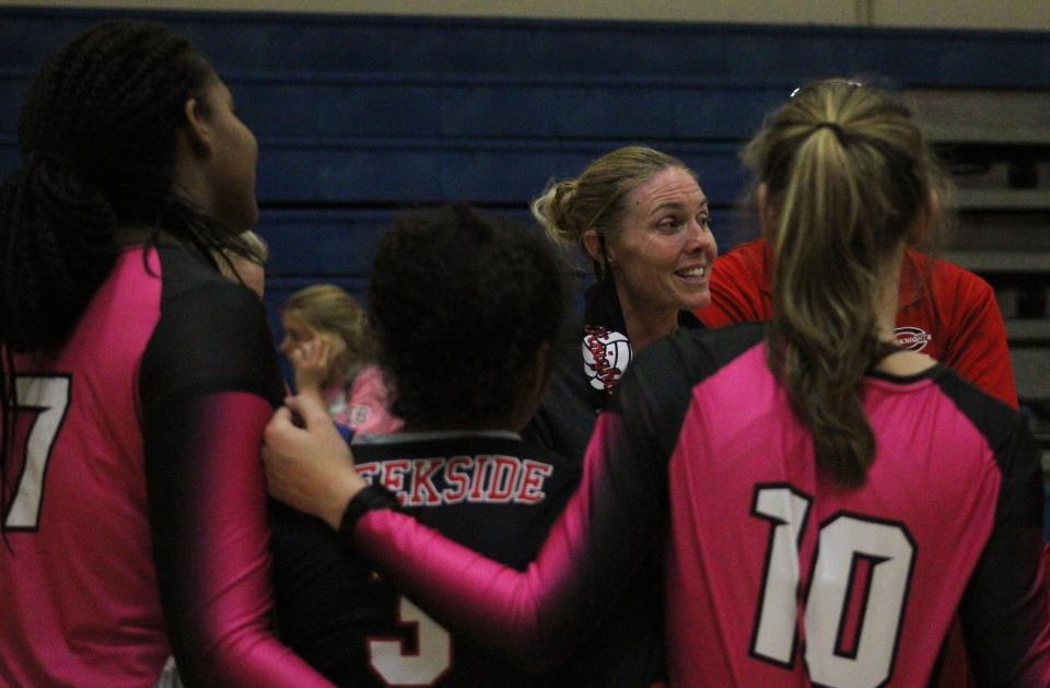 Creekside volleyball coach Megan Bowers speaks with her team during a 2020 match.