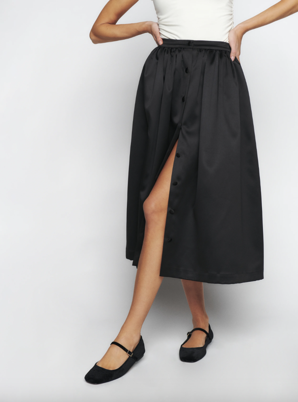 model wearing black skirt, Lola Skirt (Photo via Reformation)