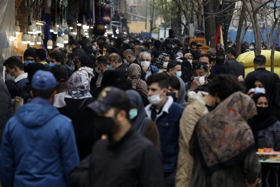 Mask-clad shoppers walk at Tehran's Grand Bazaar, ahead of the Persian New Year, or Nowruz, meaning "New Day." Iran, Monday, March 15, 2021. (AP Photo/Vahid Salemi)