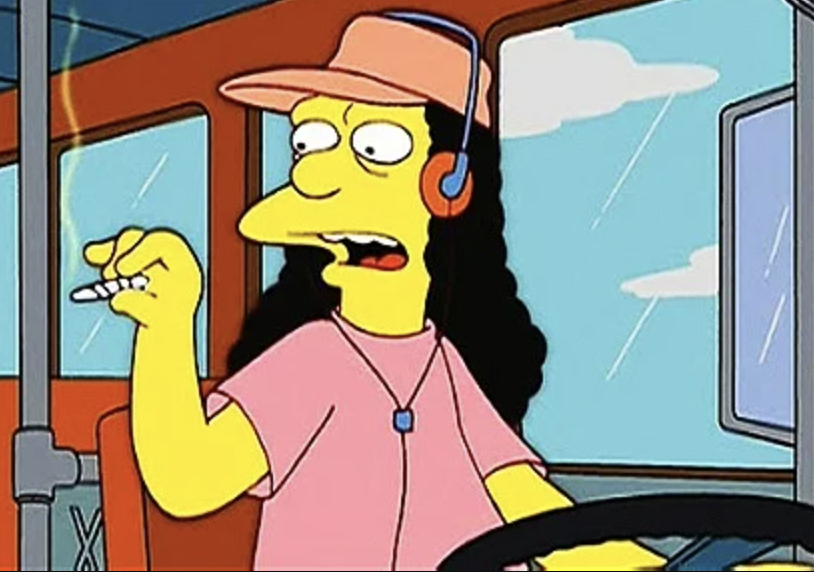 Otto sits in the drivers' seat of a bus, holding a cigarette, headphones on his ears