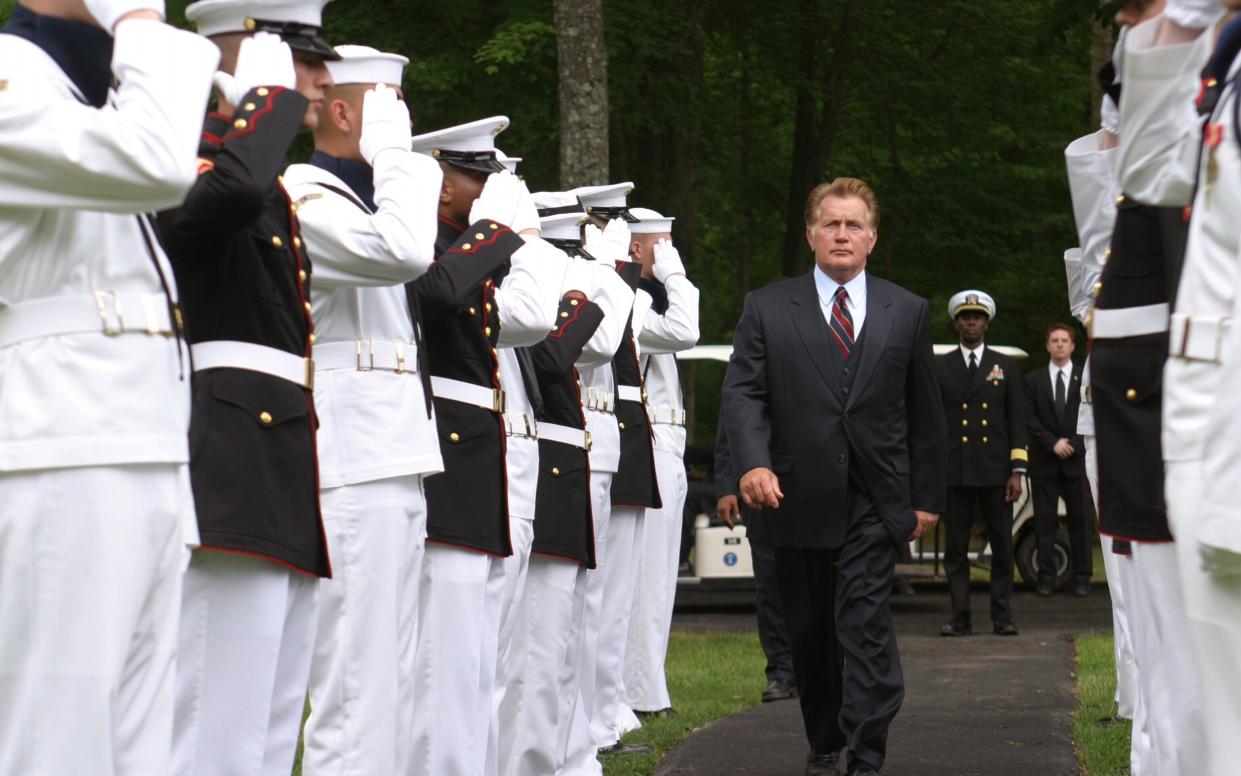 Full shot of Martin Sheen as President Josiah Bartlet walking between Marines in military uniform