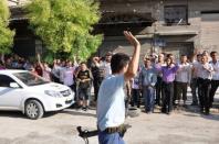 A Syrian rebel fighter salutes locals chanting slogans in support of the anti-regime uprising in the Shaar district of Aleppo. Syrian rebels staved off a fightback by regime forces in Aleppo on Saturday amid growing concern about the risks of reprisals against civilians in the country's commercial capital