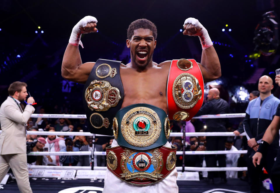 DIRIYAH, SAUDI ARABIA - DECEMBER 07: Anthony Joshua poses for a photo with the IBF, WBA, WBO & IBO World Heavyweight Title belts after the IBF, WBA, WBO & IBO World Heavyweight Title Fight between Andy Ruiz Jr and Anthony Joshua during the Matchroom Boxing 'Clash on the Dunes' show at the Diriyah Season on December 07, 2019 in Diriyah, Saudi Arabia (Photo by Richard Heathcote/Getty Images)