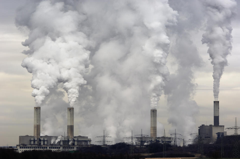 Smokestacks of a coal burning power plant with pollution on a cloudy day. (Photo: Getty Images)