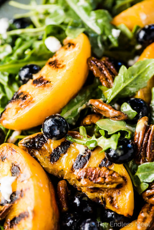 <p>The Endless Meal</p><p>Peaches are grilled until smoky and extra sweet and served with arugula, blueberries, candied curry pecans, and a honey vinaigrette.</p><p><strong>Get the recipe: <a href="https://www.theendlessmeal.com/grilled-peach-salad/" rel="nofollow noopener" target="_blank" data-ylk="slk:Grilled Peach Salad;elm:context_link;itc:0;sec:content-canvas" class="link ">Grilled Peach Salad</a></strong></p>