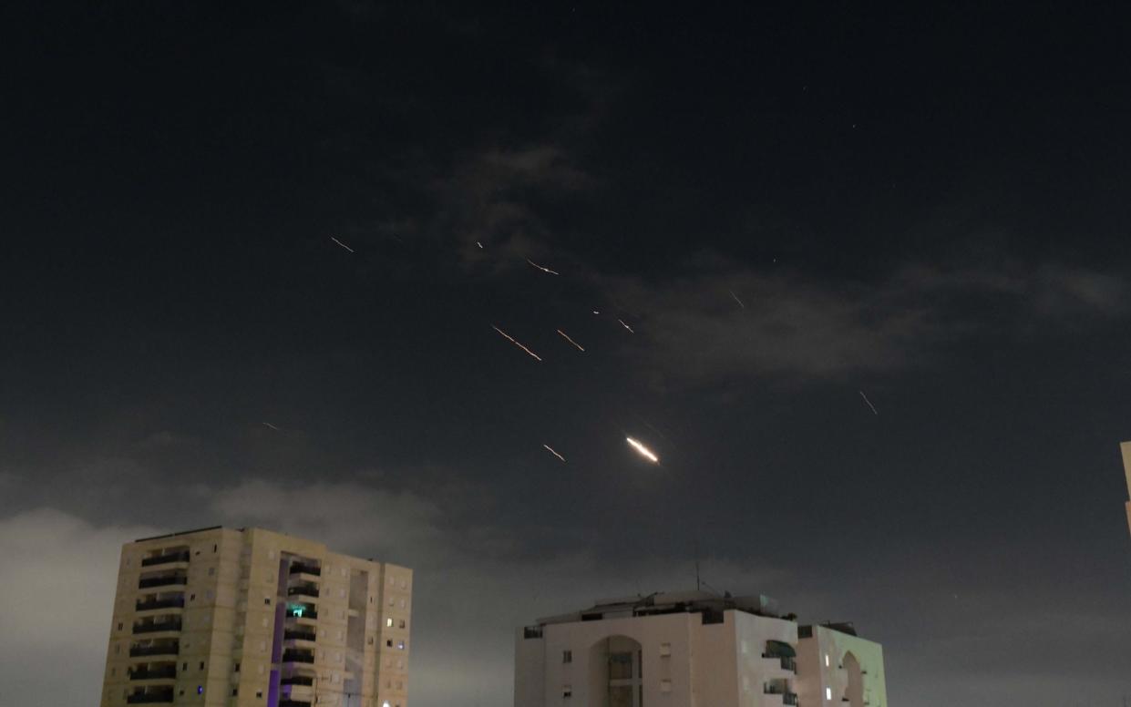 Flares from explosions in the sky over Tel Aviv as Israel's anti-missile system intercepts missiles and drones from Iran