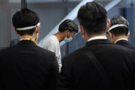 Yuki Kitazumi, a Japanese freelance journalist detained by security forces in Myanmar in mid-April and accused of spreading fake news criticizing the military coup, bows after speaking to media upon his arrival at Narita International Airport, in Narita, east of Tokyo. (AP Photo/Eugene Hoshiko)