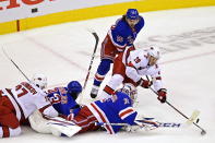 New York Rangers' goaltender Igor Shesterkin (31) stops Carolina Hurricanes' Sebastian Aho (20) as Rangers' Artemi Panarin (10) defends and Hurricanes' Andrei Svechnikov (37) and Rangers' Mika Zibanejad (93) battle during second period NHL Eastern Conference Stanley Cup playoff action in Toronto on Tuesday, Aug. 4, 2020. (Frank Gunn/The Canadian Press via AP)