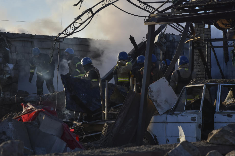 Members of the Ukrainian State Emergency Service clear the rubble at the building which was destroyed as a result of Russian strike in Zaporizhzhia district, Ukraine, Friday, March 31, 2023. (AP Photo/Andriy Andriyenko)