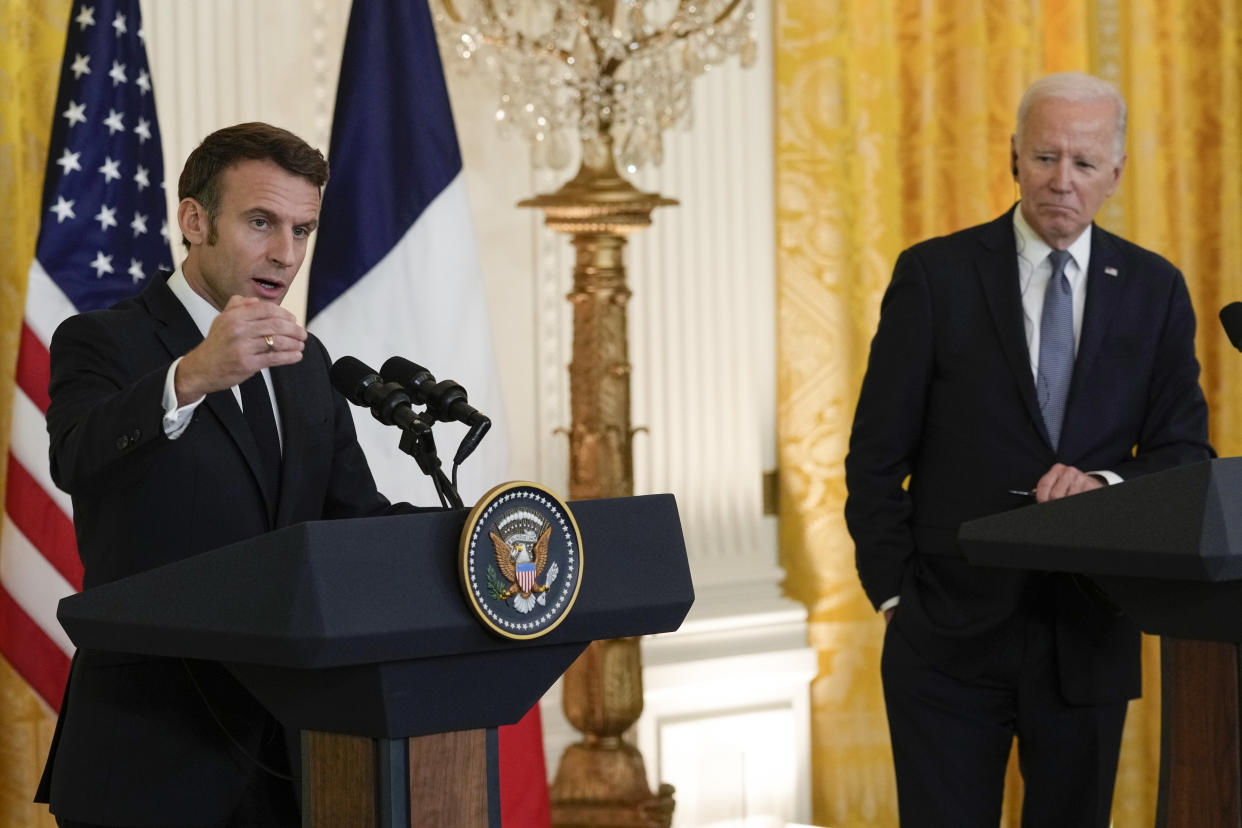 French President Emmanuel Macron speaks at a news conference with President Biden.
