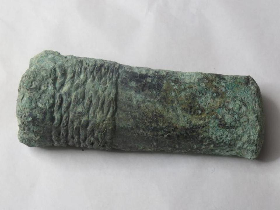 A Bronze Age hammer was found inside an ancient house, experts said.