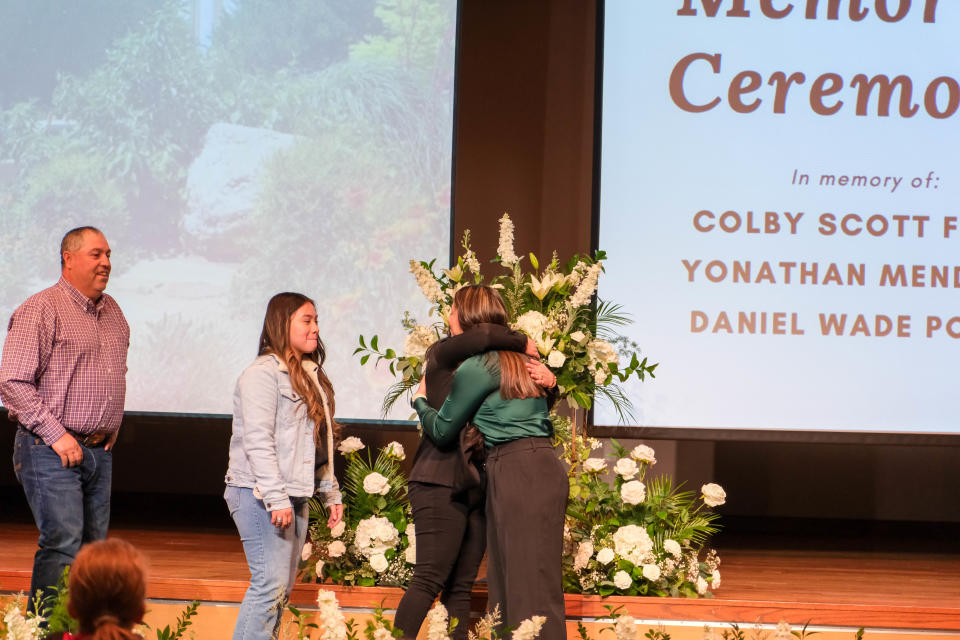 Ximena Badillo gets congratulated for receiving a scholarship in the memory of Yonathon Mendoza Friday at a student memorial service at West Texas A&M in Canyon.