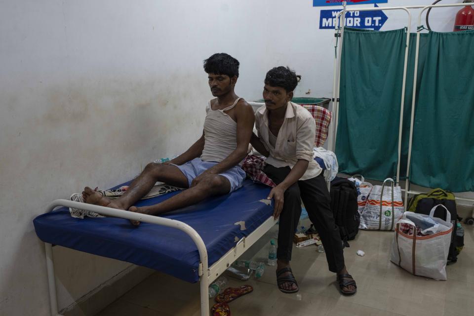 Pantry worker Inder Mahato, 37, left, is receives treatment at a hospital in Balasore district, in the eastern state of Orissa, India, Sunday, June 4, 2023. The derailment in eastern India that killed 275 people and injured hundreds was caused by an error in the electronic signaling system that led a train to wrongly change tracks and crash into a freight train, officials said Sunday. (AP Photo/Rafiq Maqbool)