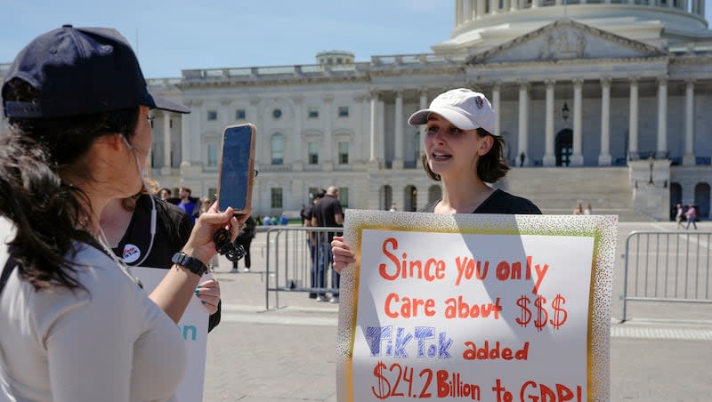 A TikTok content creator speaks to reporters outside the U.S. Capitol, Tuesday, April 23, 2024, in Washington. Tuesday night, Senators passed legislation that would force TikTok's China-based parent company to sell the social media platform under the threat of a ban.