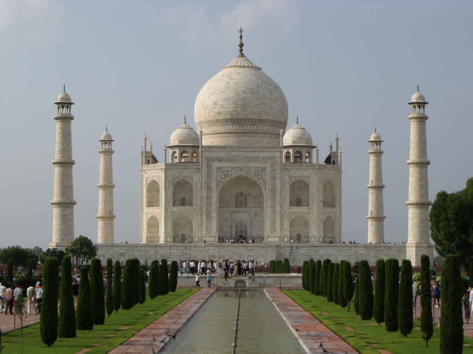 A large domed building with four pillars alongside it