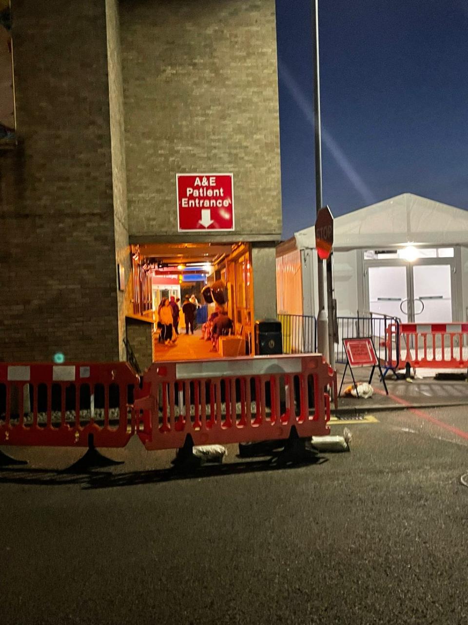 Patients wait under heat lamps outside Addenbrooke’s Hospital A&E department (Handout)