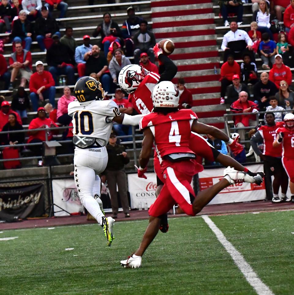 La Salle's Koy Beasley (9) breaks up a pass intended for Moeller's Tennel Bryant (10) at the Moeller vs. La Salle GCL-South football game, Sept. 23, 2022.