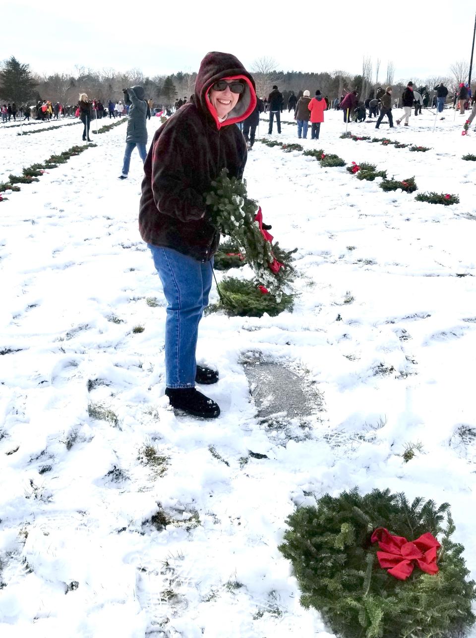 Rep. Morgan places a memorial wreath on a grave at the Rhode Island Veterans Memorial Cemetery in Exeter. She has been a dedicated supporter of the Wreaths Across America program for several years.