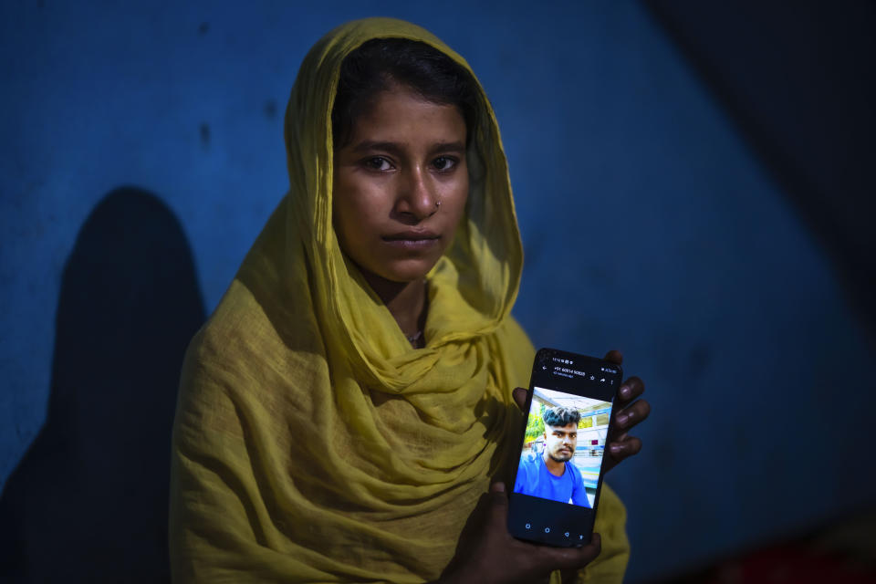 Sonali Begum, 17, displays a photo of her husband Siddique Ali, 23, who was picked up by the police, at her rented house in Guwahati, India, Saturday, Feb. 4, 2023. Indian police have arrested more than 2,000 men in a crackdown on illegal child marriages in involving girls under the age of 18 a northeastern state. Begum is seven months pregnant. (AP Photo/Anupam Nath)