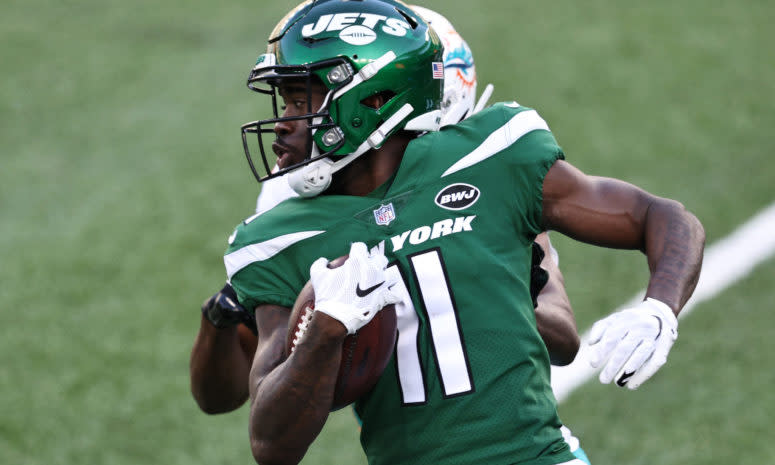 Denzel Mims runs with the ball for the New York Jets against the Miami Dolphins.