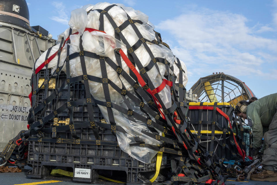 FILE - In this image released by the U.S. Navy, sailors assigned to Assault Craft Unit 4 prepare material recovered off the coast of Myrtle Beach, S.C., in the Atlantic Ocean from the shooting down of a Chinese high-altitude balloon, for transport to the FBI, at Joint Expeditionary Base Little Creek in Virginia Beach, Va., on Feb. 10, 2023. U.S. officials say the military has finished efforts to recover the remnants of the large balloon and analysis of the debris so far reinforces conclusions that it was a Chinese spy balloon. (Ryan Seelbach/U.S. Navy via AP, File)