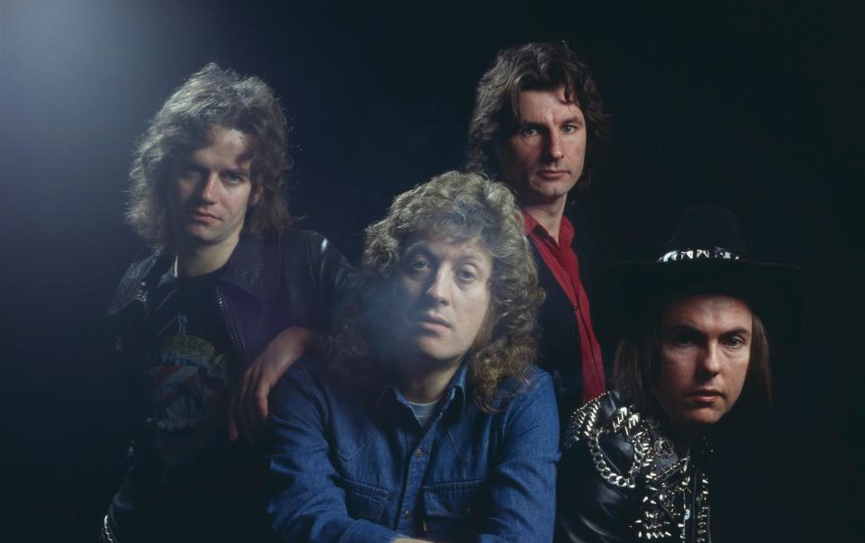 Studio portrait of English rock group Slade, posed in London circa 1975. Clockwise, from front: singer Noddy Holder, bassist Jim Lea, drummer Don Powell and guitarist Dave Hill - Michael Putland /Hulton Archive 