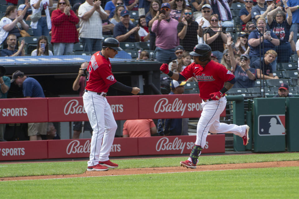 Cleveland Guardians' Jose Ramirez, right, is congratulated by third base coach Mike Sarbaugh after hitting a solo home run off Texas Rangers starting pitcher Cody Bradford during the fourth inning of a baseball game in Cleveland, Sunday, Sept. 17, 2023. (AP Photo/Phil Long)