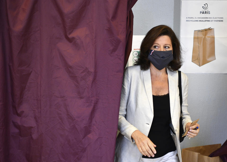 Agnes Buzyn, candidate for the presidential party La Republique en Marche (LREM) in the second round of municipal elections, leaves the voting booth before voting Sunday, June 28, 2020 in Paris. France is holding the second round of municipal elections in 5,000 towns and cities Sunday that got postponed due to the country's coronavirus outbreak. (Christophe Archambault, Pool via AP)