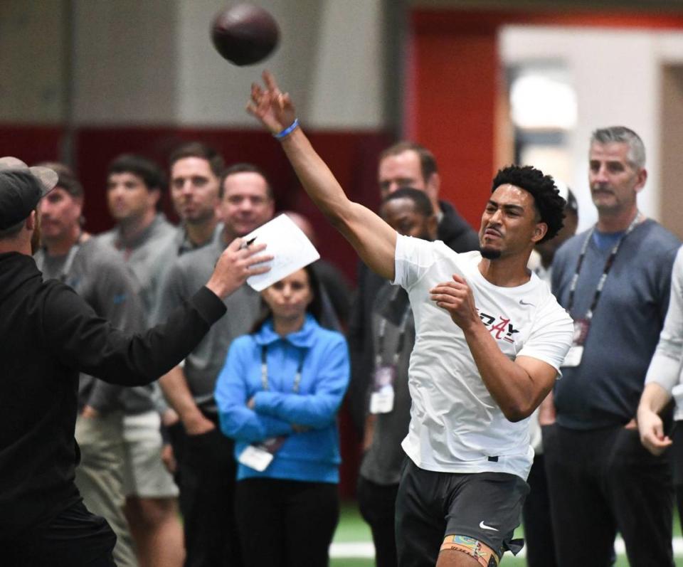Bryce Young throws during Alabama’s pro day in 2023 while being watched by new Carolina Panthers head coach Frank Reich (far right) and several other Panthers officials.