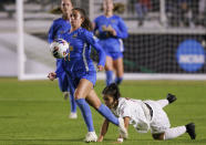 UCLA's Lexi Wright (17) works with the ball next to Alabama's Gessica Skorka (7) during the first half of an NCAA women's soccer tournament semifinal in Cary, N.C., Friday, Dec. 2, 2022. (AP Photo/Ben McKeown)