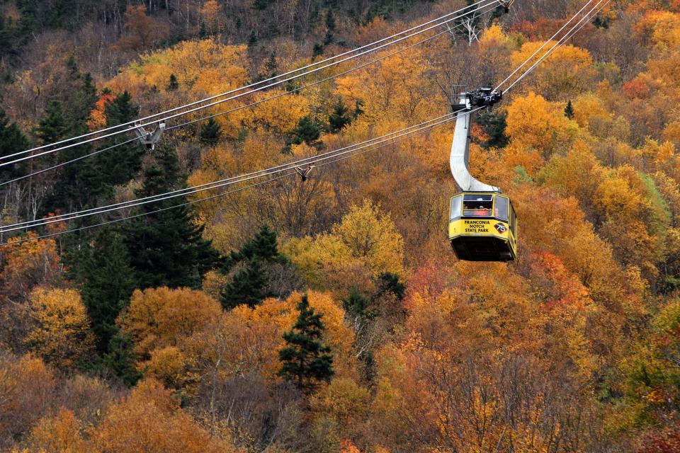 Tourists ride the tramway at Franconia Notch State Park as the autumn leaves begin to change color Oct. 4, 2013 in Franconia, N.H. Thousands of people come to New England to see the fall colors.