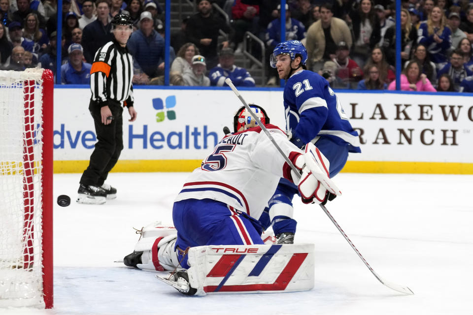 Tampa Bay Lightning center Brayden Point (21) scores past Montreal Canadiens goaltender Sam Montembeault (35) during the second period of an NHL hockey game Sunday, Dec. 31, 2023, in Tampa, Fla. (AP Photo/Chris O'Meara)