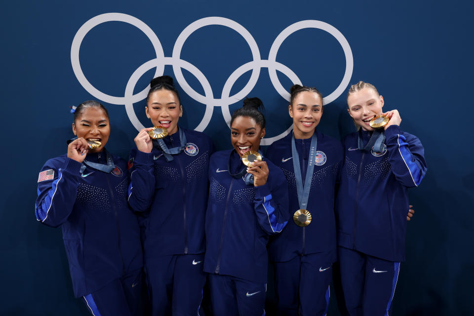 PARIS, FRANCE - JULY 30: (L-R) Gold medalists Jordan Chiles, Sunisa Lee, Simone Biles, Hezly Rivera and Jade Carey of Team United States pose with the Olympic Rings during the medal ceremony for the Artistic Gymnastics Women's Team Final on day four of the Olympic Games Paris 2024 at Bercy Arena on July 30, 2024 in Paris, France. (Photo by Naomi Baker/Getty Images)