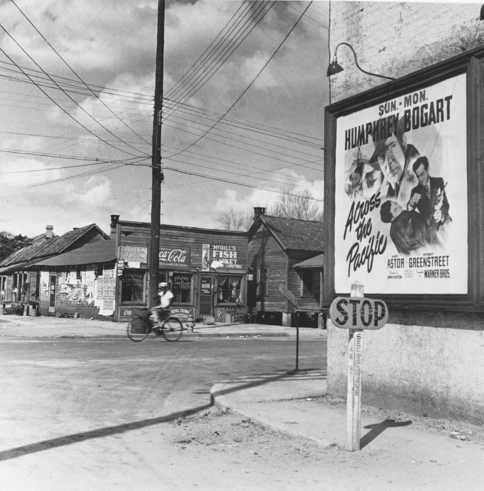 Second Avenue in Daytona Beach's Midtown neighborhood, now called Mary McLeod Bethune Boulevard, had a very different look in the early 1940s, as shown in this photograph. Even the stop signs and street signs were rudimentary, combined into one unit on a small wooden post.