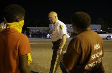 St. Louis County Police Chief Jon Belmar with protesters in Ferguson, Mo., Tuesday. (AP Photo/Jeff Roberson)