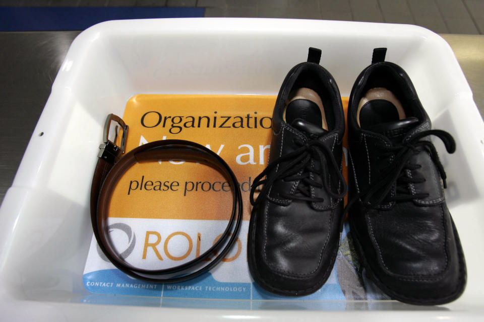 FILE - In this Wednesday, Jan. 10, 2007, file photo, a belt and shoes sit in a trays with advertising that is being used in the safety screening of travelers done by the Transportation Security Administration, at the Los Angeles International Airport in Los Angeles. The U.S Department of Homeland Security said Wednesday, Feb. 19, 2014, it is warning airlines that terrorists could try to hide explosives in shoes. It's the second time in less than three weeks that the government has issued a warning about possible attempts to smuggle explosives on a commercial jetliner. (AP Photo/Ann Johansson, File)