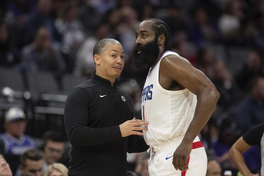 Los Angeles Clippers head coach Tyrone Luis, left, talks with guard James Harden (1) in the second half of an NBA basketball game against the Sacramento Kings in Sacramento, Calif., Wednesday, Nov. 29, 2023. (AP Photo/José Luis Villegas)