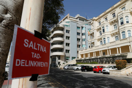 A placard reading: "A kingdom of delinquents" is seen outside Whitehall Mansions, which houses the Maltese-registered Pilatus Bank, in Ta' Xbiex, Malta March 21, 2018. REUTERS/Darrin Zammit Lupi