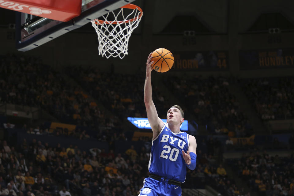 BYU guard Spencer Johnson (20) shoots against West Virginia during the first half of an NCAA college basketball game Saturday, Feb. 3, 2024, in Morgantown, W.Va. (AP Photo/Kathleen Batten)